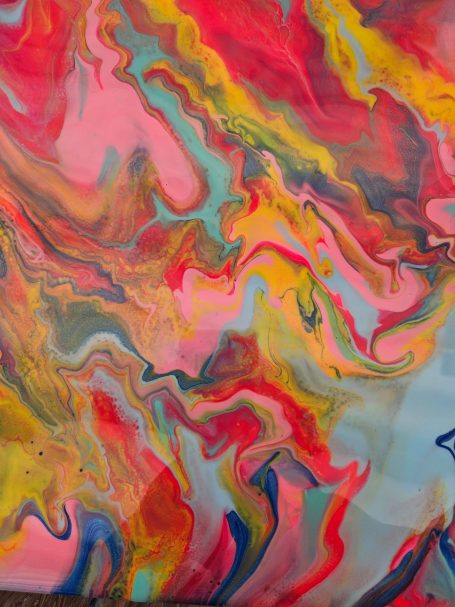 Alexreart Colourful abstract swirl of pink, yellow, blue, and orange tones.